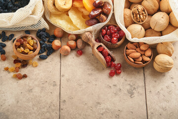 Tu Bishvat celebration concept Mix of dry fruits and almonds, hazelnuts, walnuts, apricots, prunes, cherries, raisins, dates, apples, figs on old tile table background Jewish holiday new year of trees