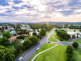 Single ray of light shining down over town of singleton on summer evening