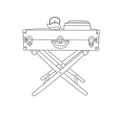 suitcase table with books and teapot