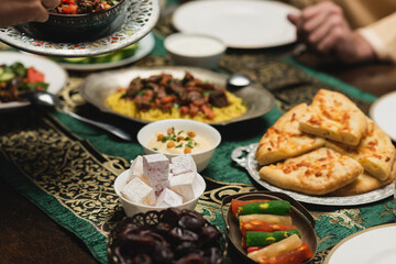 Cropped view of delicious food near muslim family during ramadan dinner.