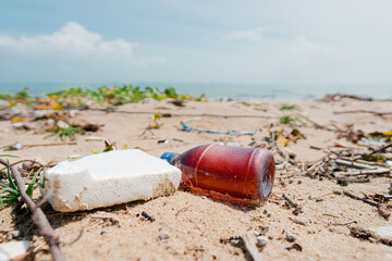 A lot of trash on the beach, plastic cups, and plastic bags. Marine debris is one of the world's major environmental problems. Conserving the environment and marine nature