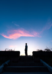 silhouette of a person on the top of the hill
