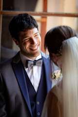 Groom in love and happy looks at his bride