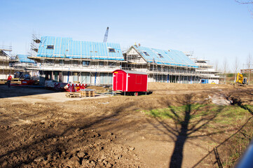 Obraz premium Terraced houses under construction with two construction workers on the roof in Nijmegen, Netherlands