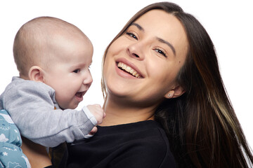 Young girl with a baby in her arms, joy with a newborn laughing