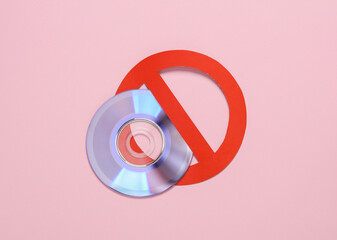 Cd disk with prohibition sign on pink background