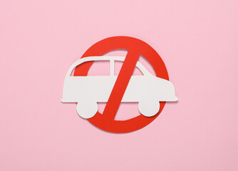 Paper cut car with prohibition sign on pink background