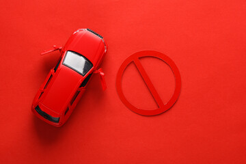 There is no travel. Car model with a prohibition sign on red background