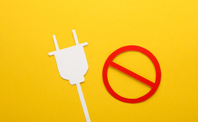 Paper-cut electric plug with a prohibition sign on yellow background