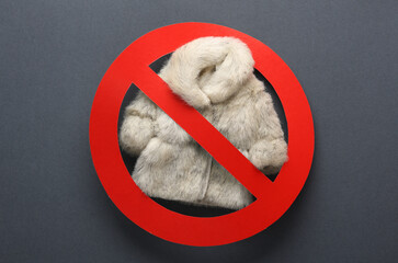 Animal welfare, say no to natural fur. Fur coat with a prohibition sign on a dark background