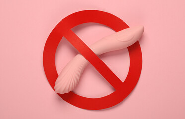 Vibrator with prohibition sign on pink background