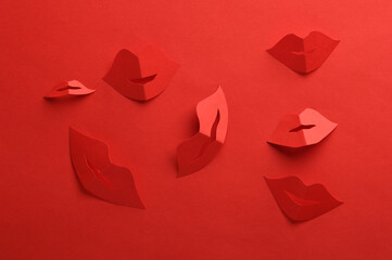 Paper cut red lips on red background