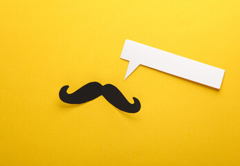 Paper-cut mustache with a speech bubble on a yellow background. Creative layout