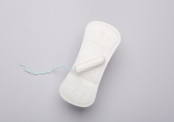 Menstrual pad with tampon on gray background. Women's intimate hygiene