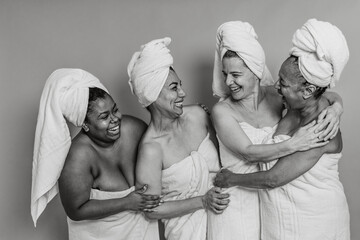 Happy multiracial women with different ages and body size having skin care spa day - People wellness and selfcare concept - Black and white editing