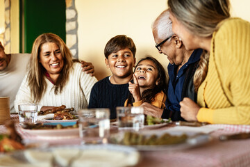 Happy Latin family having fun lunching together at home - 575047279