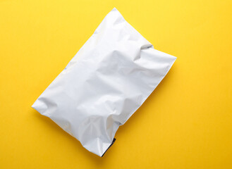 Parcel package mockup on yellow background. Top view
