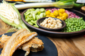Close-up of dried cod with defocused legumes in the background