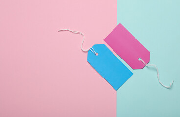Colored Blank clothing price tags or labels mockup with strings on pink blue background. Sale,...