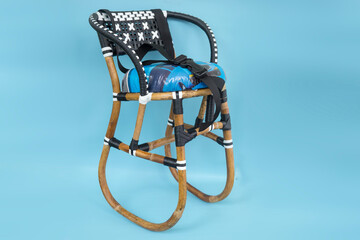 Fototapeta na wymiar accessory baby seat for motorcycle made of rattan isolated on blue background.
