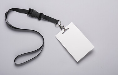 Empty white ID card badge mockup with black belt on gray background. Staff identity name tag. Space...