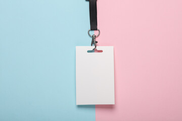 Empty white ID card badge mockup with black belt on pink blue background. Staff identity name tag....