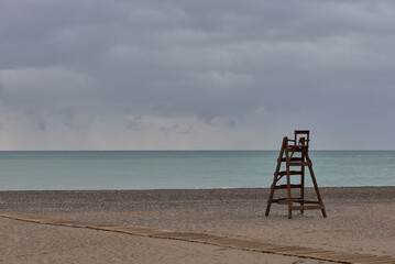 A wooden lifeguard chair on lonely beach