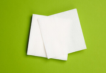 White paper napkins on a green background. Top view