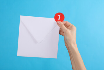 Hand holding envelope and Notification with 1 number on blue background. Social media, message, sms, subscribe notice alert and reminder.