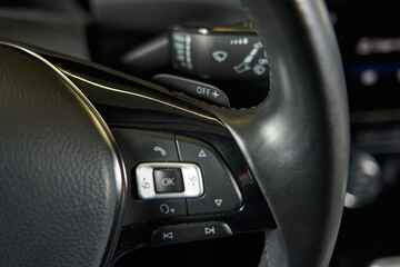 Fototapeta na wymiar car steering wheel paddles, multimedia adjustment and flipping through song tracks on the steering wheel spoke