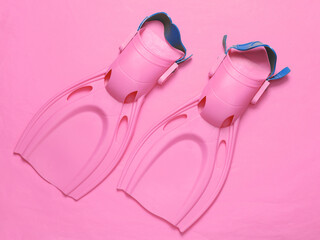 Diving fins on a pink background. Top view. Flat lay