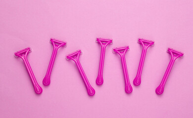 Set of disposable razors for depilation on pink background. Top view