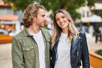 Man and woman couple smiling confident standing together at street