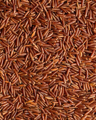 Texture of Organic Raw Red Rice. Red Rice Background. Healthy Eating Concept