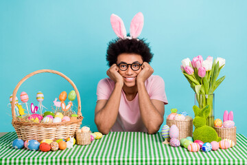 Photo of young satisfied dreamy attractive guy touch cheeks smiling desk easter spring holiday...