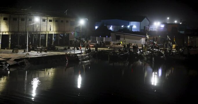 Cape Coast Ghana African fishing village fleet night. Fishing village market Africa. Crowded buying, selling and barter. Handmade fishing boats. Only source of income for community.