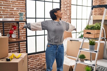 Young woman smiling confident standing at new home