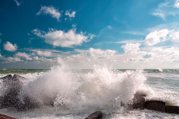 Raging waves crashing on a stone pier. Sea element.
