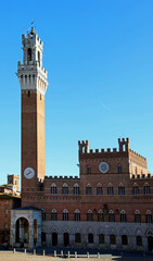 Fototapeta na wymiar Bell Tower called TORRE DEL MANGIA in Siena City in Italy