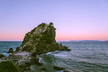 Foto op Plexiglas Agios Ioannis Church on Skopelos,  Greece, where scenes of Mamma Mia were filmed in a sunset with a calm sea and the coast © Eva