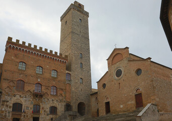 Obraz premium Town hall and church and medieval tower in the ancient village of San Gimignano in the Tuscany region in Italy