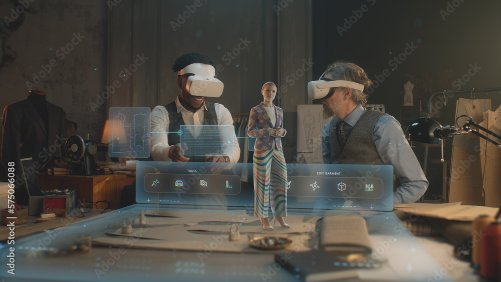 Wall mural two multi ethnic tailors in vr headsets in atelier. 3d female hologram of garment pattern. virtual i