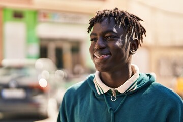 African american man smiling confident looking to the side at street