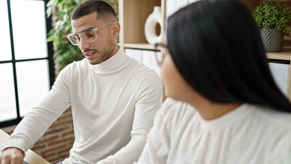 Fototapeta premium Man and woman business workers working together at office