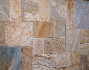 Abstract Corner View of a Tan and Brown Sandstone Wall.