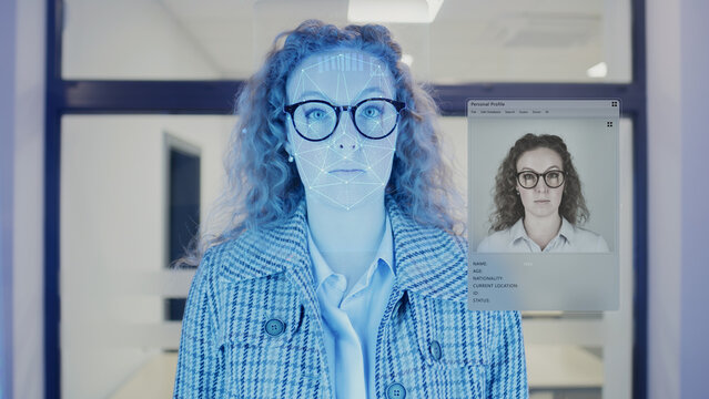 Woman scans face in office. She touches sensor and security system identifies. 3D hologram of human biometric facial recognition and personal virtual profile. Privacy, identification and AI technology