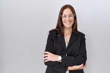 Beautiful brunette woman wearing business jacket and glasses happy face smiling with crossed arms looking at the camera. positive person.