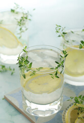 Glasses with lemon and thyme refreshing drink