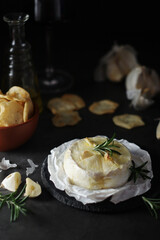 Baked Camembert cheese with rosemary and garlic	