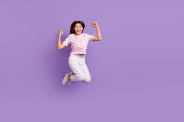 Full body photo of overjoyed cheerful person raise fists success empty space isolated on violet color background